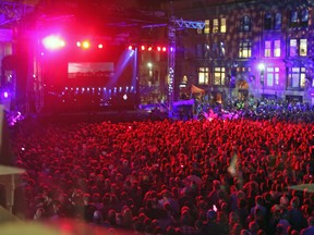 More than 25,000 fans gather at Springer Market Square to watch the live streaming of The Tragically Hip concert at the Rogers K-Rock Centre on Saturday night. (Steph Crosier/The Whig-Standard)