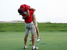 An emotional Hunter McGee, 14, hugs dad and playing partner Allen McGee after capturing the Sun Scramble Flagstick Open Championship last year. More than a 1,000 golfers will compete in this year’s tournament. (Ottawa Sun/files)