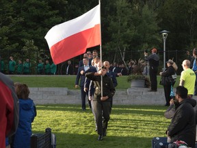 Members of the Polish contingent enter the amphitheatre at Bell Park for the start of the International Mines Rescue Competition on Sunday. (Mary Katherine Keown/The Sudbury Star)