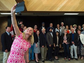 Minister of Environment and Climate Change Catherine McKenna, left, takes a selfie with members of the Liberal cabinet at their Liberal cabinet retreat in Sudbury, Ont., on Sunday, August 21, 2016. THE CANADIAN PRESS/Nathan Denette
