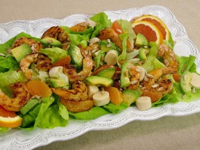 This July 29, 2016 photo shows a salad of spicy grilled shrimp with hearts of palm, avocado, and orange in New York. This dish is from a recipe by Sara Moulton.