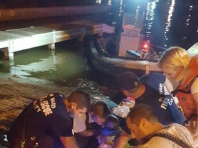 Cocoa Police officers with assistance from multiple agencies and several civilians rescued a family of four including a toddler and an infant after their boat crashed and overturned in the Indian River near the Hubert Humphrey Bridge in Cocoa, Florida, August 19, 2016. (Cocoa Police Department photo)