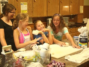 A few laughs while preparing yogurt flat bread.(Shaun Gregory/Huron Expositor)