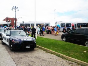 U.S. refugees are shown in this Sarnia police photo, Via Twitter, boarding buses in downtown Sarnia Sunday after being blown to the Canadian shore of the St. Clair River during the Port Huron Float Down.
Handout/Sarnia Observer/Postmedia Network