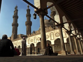 In this Dec. 28, 2012 file photo, Muslim men wait for the Friday noon prayer at Al-Azhar Mosque in Cairo, Egypt. (AP Photo/Khalil Hamra, File)