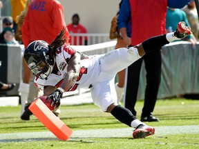 Atlanta Falcons running back Devonta Freeman scores on a 5-yard run against the Jacksonville Jaguars Sunday, Dec. 20, 2015. (AP Photo/Phelan M. Ebenhack)