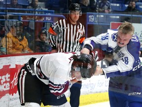 Sudbury Wolves forward Macauley Carson tangles with Levi Tetrault of the Guelph Storm at Sudbury Community Arena last season. The OHL announced rule changes that will keep OHLers to three fights per season before facing supplemental discipline. Gino Donato/The Sudbury Star