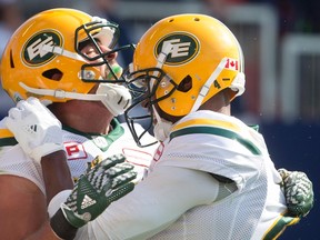 Eskimos receivers Nate Coehoorn, left, and Adarius Bowman celebrate a touchdown during Saturday's game against the Argos in Toronto. (The Canadian Press)