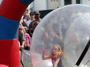 Adilyn Haggith, 6, has fun as she is in the large Hamster Ball inflatible at WallyFest held in downtown Wallaceburg on Saturday, August 20. The event, which is in its first year, featured vendors and activities for kids.