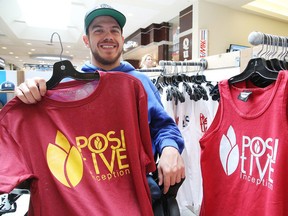 Ryan Benoit shows off some of his  Positive Inception clothing at the New Sudbury Centre on Monday. (Gino Donato/Sudbury Star)