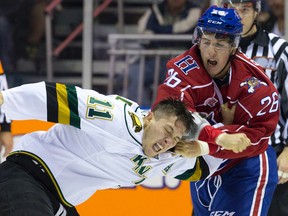 London Knights forward Owen MacDonald and Hamilton Bulldogs forward Jake Bricknell fight during an OHL game at Budweiser Gardens last season. (File photo)