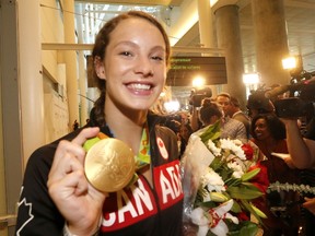 Penny Oleksiak arrives at Pearson airport on Tuesday, Aug. 23, 2016 with the gold medal she won at the 2016 Olympic Summer Games in Rio de Janeiro, Brazil. Michael Peake/Toronto Sun/Postmedia Network