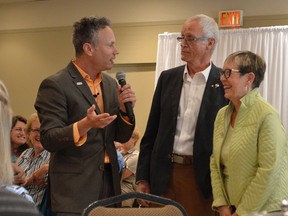 Michael Caruso talks with Rotarians Tony Hill and Jennifer Hill during his presentation at an early Rotary-sponsored event in Chatham Aug. 23. Caruso, a professional speaker, spoke as part of the club's new Go Public with Rotary initiative.