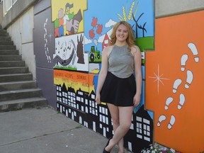 Liessell Innes stands in front of the mural she designed and painted with a team of students for International Youth Day in Chatham. The event was initially scheduled for Aug. 12 but a heat wave and rain pushed the outdoor mural unveiling to this Wednesday.