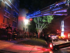 Chicago firefighters battle an apartment fire in the 8100 block of South Essex Avenue in the South Chicago neighbourhood early on Tuesday, Aug. 23, 2016. The fire at a Chicago apartment building that appears to have been deliberately set killed multiple people Tuesday, police said. (Alexandra Chachkevitch/Chicago Tribune via AP)