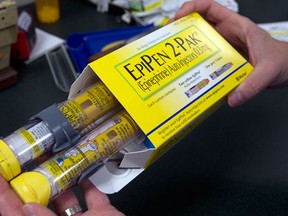 FILE - In this July 8, 2016 file photo, a package of EpiPens, an epinephrine autoinjector for the treatment of allergic reactions is displayed in Sacramento, Calif. Lawmakers are demanding more information on why the price for live-saving EpiPens has skyrocketed. EpiPens are used largely by children to ward off potentially fatal allergic reactions, and its price has surged in recent years. A two-dose package cost less than $60 nine years ago. The cost is now closer to $400. (AP Photo/Rich Pedroncelli, File)