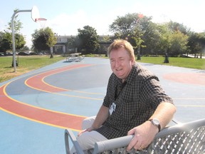 Kingston Community Health Centres' Stafford Murphy sits on a bench in the centres' new parkette on Weller Avenue in Kingston. (Michael Lea/The Whig-Standard)