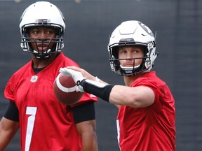 Redblacks quarterback Trevor Harris throws the ball while Henry Burris looks on at the first day of training camp at TD Place in Ottawa on Sunday, May 29, 2016. (Patrick Doyle/Postmedia Network)