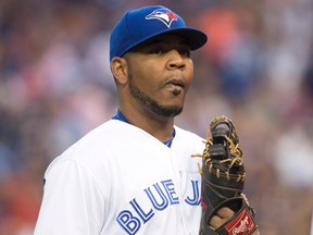 Toronto Blue Jays' Edwin Encarnacion returns to the dug out at the end of second inning in a game against the  Los Angeles Angels in Toronto on Aug. 23. (THE CANADIAN PRESS)