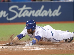 Russell Martin of the Toronto Blue Jays slides across home plate to score a run on a sacrifice fly RBI hit by Melvin Upton Jr. in the fifth inning in a game against the Los Angeles Angels of Anaheim on Aug. 23, 2016 at Rogers Centre in Toronto. (Tom Szczerbowski/Getty Images)