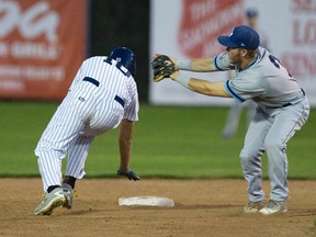 Kyle Gormandy of the London Majors scrambles back to second base as Toronto Maple Leafs infielder Ryan White catches the ball during their Intercounty Baseball League playoff game at Labatt Park Tuesday night. Gormandy was called out on the play. (CRAIG GLOVER, The London Free Press)