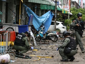 A Thai bomb squad inspects the site of a deadly bombing from the night before outside of a hotel, in the southern province of Pattani on August 24, 2016.  A large car bomb blew up outside a hotel in Thailand's insurgency-plagued southern region late, killing one and wounding more than 30 people, some of them critically, police said. Although the area is not popular with tourists, the country has been on edge since a string of small but coordinated explosions earlier this month struck resort towns further north. (AFP PHOTO/TUWAEDANIYA MERINGINGTUWAEDANIYA MERINGING/AFP/Getty Images)