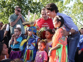 Prime Minister Justin Trudeau poses for a photo at  a community barbecue in Sudbury, Ont. on Monday August 22, 2016. Trudeau and his ministers wraped up a two-day cabinet retreat in Sudbury at Laurentian University, where the ministers bunked together in student dorms. Gino Donato/Sudbury Star/Postmedia Network