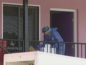 In this image made from video from the Australian Broadcasting Corporation, emergency personnel work the scene on Wednesday, Aug. 24, 2016, after an attack took place on Tuesday, at a hostel in the town of Home Hill in northern Queensland, Australia. (Australian Broadcasting Corporation via AP Photo)