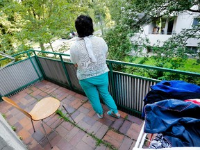 In this July 28, 2016 picture, a 17-year-old Yazidi girl stands on the balcony of her home in Germany. After escaping the clutches of Islamic State, Yasmin, a Yazidi girl, was so traumatized by her captivity that she poured gasoline on herself and set it alight -  hoping to render herself no longer desirable to the extremists. (AP Photo/Michael Probst)