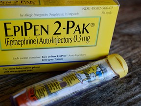This Oct. 10, 2013, file photo, shows an EpiPen epinephrine auto-injector, a Mylan product, in Hendersonville, Texas. Mylan reports financial results Tuesday, Aug. 9, 2016. (AP Photo/Mark Zaleski, File)