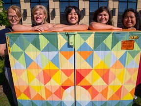 Selena Wells, Taylor Burnett, Shuko Wada, Dana Cosman and Melissa Colindres pose with a Bell telephone box they have painted near the big box stores in Hyde Park in London, Ont. on Tuesday August 23, 2016. (MIKE HENSEN, The London Free Press)