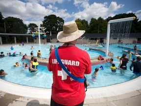 Lifeguard Kenny Grenier, who has been lifeguarding for 3 years, stands watch over a kiddie pool as dozens of children keep cool in the afternoon sun at Thames Pool in London, Ont. on Tuesday August 23, 2016. (CRAIG GLOVER, The London Free Press)