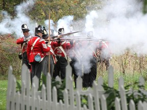 British soldiers line up and fire their muskets from the cover of a picket fence at Fanshawe Pioneer Village's War of 1812 reenactment on October 3, 2015. (Photo courtesy of Fanshawe Pioneer Village)