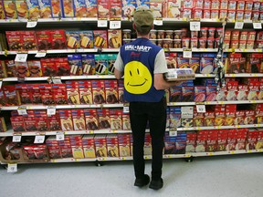 An employee restocks a shelf in the grocery section of a Wal-Mart Supercenter May 11, 2005 in Troy, Ohio. Wal-Mart, America's largest retailer and the largest company in the world based on revenue, has evolved into a giant economic force for the U.S. economy. With growth, the company continues to weather criticism of low wages, anti-union policies as well as accusations that it has homogenized America's retail economy and driven traditional stores and shops out of business.  (Photo by Chris Hondros/Getty Images)