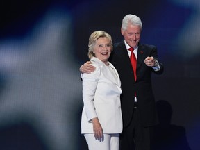 Democratic presidential nominee Hillary Clinton on stage with husband former U.S. president Bill Clinton at the Democratic National Convention at Wells Fargo Center in Philadelphia, Penn., July 28, 2016. (AFP PHOTO / SAUL LOEBSAUL LOEB/AFP/Getty Images)