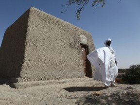 Sane Chirfi, representing the family which looks after the mausoleum of Alpha Moya, poses in front of the mausoleum on February 4, 2016 Timbuktu . Mali's fabled city of Timbuktu on February 4 celebrated the recovery of its historic mausoleums, destroyed during an Islamist takeover of northern Mali in 2012 and rebuilt thanks to UN cultural agency UNESCO. (SEBASTIEN RIEUSSEC/AFP/Getty Images)