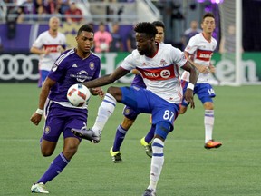 TFC’s Tosaint Ricketts moves the ball past Orlando City’s Tommy Redding to get on a breakaway on Wednesday night. (AP)