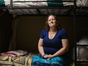 Susan Contreras sits on her bed in a Phoenix-area shelter for victims of domestic violence on Wednesday, Aug. 3, 2016. Contreras is part of a unique program at the Barrow Neurological Institute in Phoenix that aims to assist abuse survivors who have suffered head trauma. (AP Photo/Beatriz Costa-Lima)