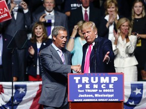 Republican presidential candidate Donald Trump welcomes Nigel Farage, ex-leader of the British UKIP party, to speak at a campaign rally in Jackson, Miss., Wednesday, Aug. 24, 2016. (AP Photo/Gerald Herbert)