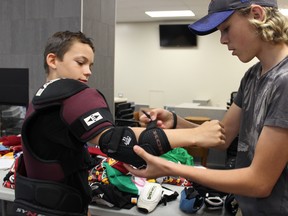 Samantha Reed/The Intelligencer

Thirteen-year-old Jacob Mattice gets outfitted with hockey equipment by volunteer Zack Goodfellow on Wednesday afternoon during the Build A Player Program event at the Quinte Sports and Wellness Centre.