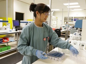 Laboratory assistant Rose Gloria at work in the Dynalife central lab facility in Edmonton.