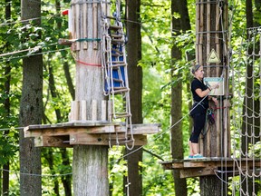 An employee closes up the Go Ape course for the day after a 59 year-old woman fell to her death at the zip line course in Lums Pond State Park in Bear, Del., Wednesday, Aug. 24, 2016. (Kyle Grantham/The Wilmington News-Journal via AP)