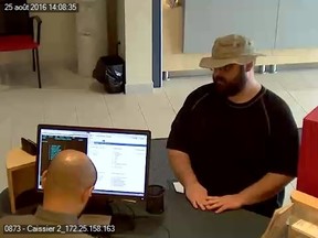 Kingston Police are searching for this suspect in a robbery at the National Bank branch on Princess Street on Thursday. (Kingston Police)