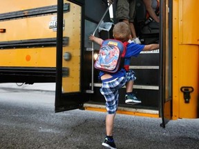 A kindergarten student boards the bus in this Sept. 4, 2012 file photo.  (AP Photo/The Kalamazoo Gazette, Mark Bugnaski)