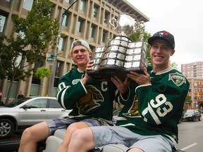 Christian Dvorak and Mitch Marner hoist the Memorial Cup as they cruise down Queens Avenue as part of the Knights parade. (Mike Hensen/Postmedia Network/The London Free Press)