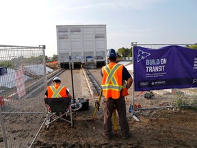 Workers monitor the progress as the last building left on the large Kodak site is moved 60 metres north for the building of the Mount Dennis Crosstown LRT station Thursday August 25, 2016. (Michael Peake/Toronto Sun)