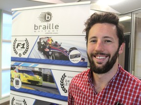 Liam Burtt stands in the offices of Braille Battery Inc., in Kingston on Wednesday. The company is sponsoring and hosting a large-scale car meet in Kingston on Saturday. More than 200 cars are expected to be on display. (Michael Lea/The Whig-Standard)