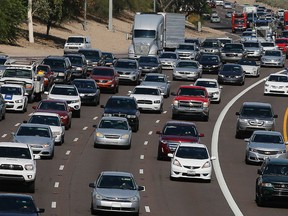 In this June 24, 2015, file photo, afternoon rush our traffic moves along a highway in Phoenix. (AP Photo/Ross D. Franklin, File)