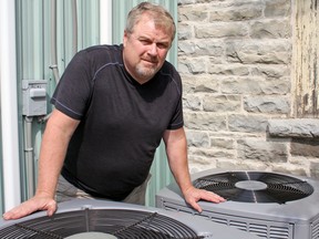 John Beskers, acting-president of the Storrington Lions Club, at the club's air conditioning units in Inverary. (Steph Crosier/The Whig-Standard)