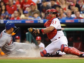 New York Mets’ Juan Lagares, left, scores past Philadelphia Phillies catcher Carlos Ruiz Saturday, July 16, 2016, in Philadelphia. (AP Photo/Matt Slocum)